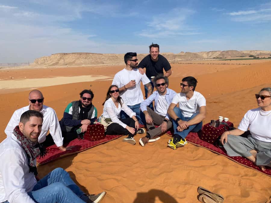 VIP Red Dunes: Camel, Quads, Private Tour & Coffee - Sandboarding turns the dunes into a playground